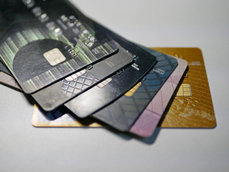 Selective foucs of mixed debit and credit cards on a white background