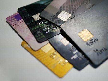 Selective foucs of mixed debit and credit cards on a white background