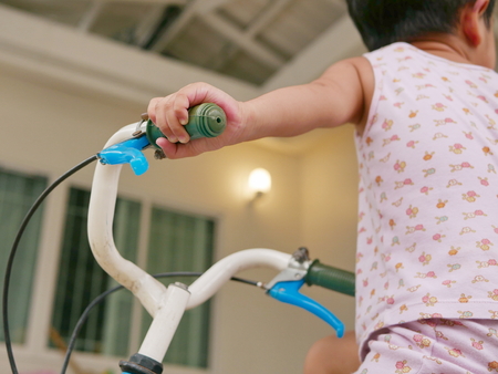 Little baby's hands, 32 months old, holding handlebars learning to ride a bicycleの写真素材