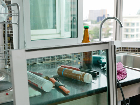 Selective focus of on-the-field tools and equipments that the technician using for sliding window installationの写真素材