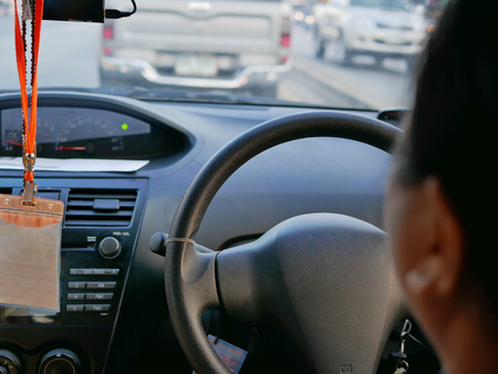 Front console of a driving car in Thailand, driving on the right lane, and so the steering wheel is...