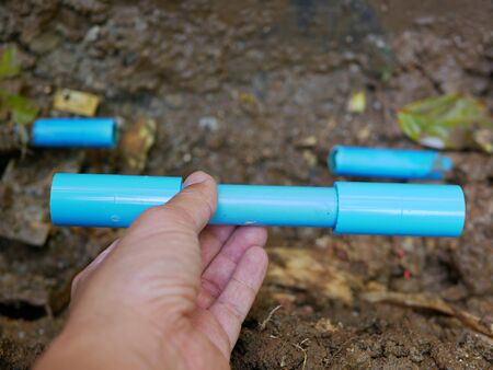 Selective focus of broken / leaked / cracked PVC water pipe underground is about to be fixed by...