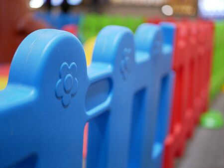 Selective focus background of colorful plastic fence of an indoor playground
