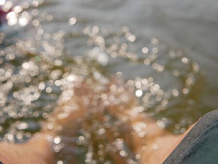 Blurry background of bare feet in refreshing natural water stream