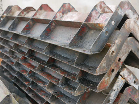 Metallic molds for building a concrete fence covered with oil to help prevent them from becoming...