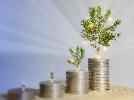 Growing money, plant or tree grows on stack of coins with light rays and glowing flying particles....