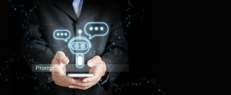 Chatbot in a businessman's hand with a text input box ready to gather users' prompt or inputs.の写真素材