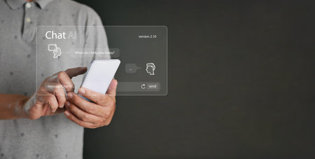 Chat ai concept. A man chats with AI on a smartphone. Chatting with a smart artificial intelligence, a customer chatbot service application, using command prompt to generate outputs.の写真素材