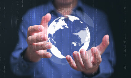 whole world in your hands concept. Digital globe in a businessman's hand with binary code...