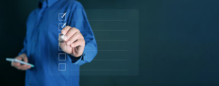 Business checklist concept. A man with a stylus checking online performance checklist form. Digital survey, online assessment, evaluation, questionnaire, research, feedback, and teの写真素材