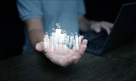 Percentage increase  concept. A man with rising percent bar graph representing the rise of  return on investment, interest rate, inflation, discount, tax, mortgage, and dividendの写真素材