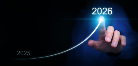 Happy new year. A businessman draws a line rising up, from 2025 to  2026, representing aimed growth,...