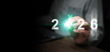 A man, with a dart in his hand, aiming at year 2026 to set and focus on new goal for the coming new...