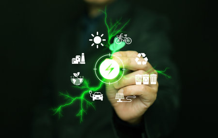 Green energy concept. A man with a dart aiming at icons of sustainable renewable power sources with green lightning boltsの写真素材