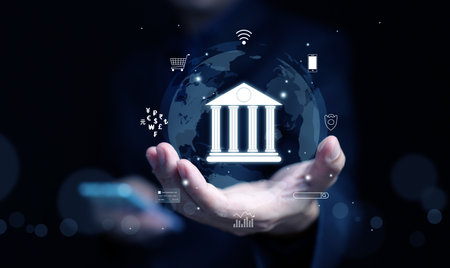 Online digital banking and financial technology concept: A man uses his smartphone to access mobile transactions worldwideの写真素材