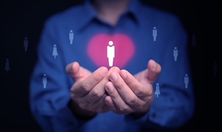 Customer Care Concept. A person holding protected customer icon in a heart symbol.の写真素材