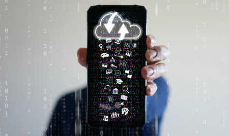 Cloud Computing Concept â A man uses a smartphone to upload and download IT resources via cloud technology, featuring binary code, data streams, networking, and digital delivery systemsの写真素材