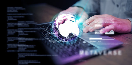 Metaverse and virtual reality technology: a man using his laptop to access an augmented world...