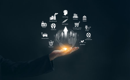 Global industries economy growth concept with glowing world in businessman hand, technology, finance, healthcare, manufacturing, and worldwide economic development strategy.の写真素材