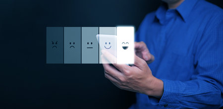 Businessman choosing smiley face emoji on satisfaction bar via mobile phone, symbolizing customer...
