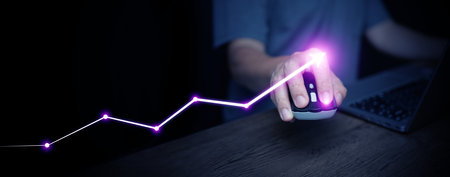 Business growth chart with neon arrow and hand on mouse, representing success, progress, leadership, and innovation. Perfect for startup, e-commerce, and financial strategy presentations.の写真素材