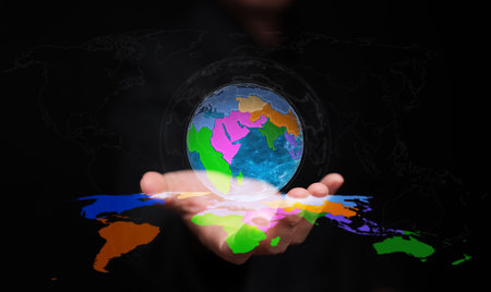 Futuristic holographic globe with regional divisions represents regionalism, world trade, and sustainable growth through international cooperation and innovation.の写真素材