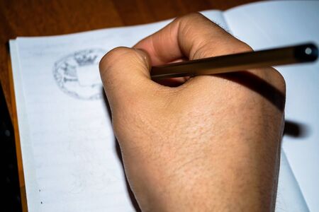 Hobbies drawing the human hand holding a pencil