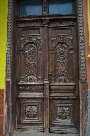 the architecture of the old wooden door with beautiful carvingsの写真素材