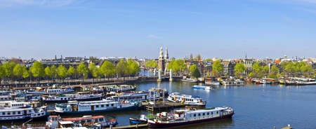 Classical Amsterdam view. Boat floats on the channel on the background of bridge. Urban scene.の写真素材