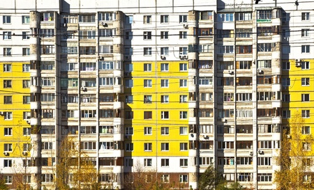 Social facade of an apartment building. Different balconies and yellow panels. Sleeping areas of...