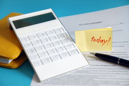 Business still life with yellow diaries, contracts, pen and a reminder の写真素材