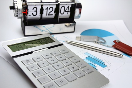 On a table the pen, the calculator, flash card, schedules, clockの写真素材