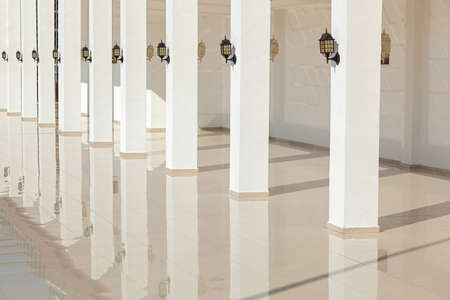 The columns of the building reflect on a smooth floorの写真素材