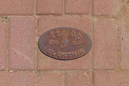 Alanya, Turkey May 6: A metal plate with the image of a company name is attached to the floor tile...