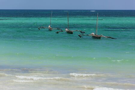 Three boats. Three boats as if lined up rocking on the azure waves.