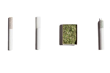 Cigarettes with weed.Open box with hemp, one empty cigarette and two filled with tobacco and cannabis isolated on white background.の写真素材