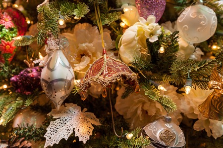 New Year toys. Close up of the toy in form of umbrella against decorative New Year tree.の写真素材