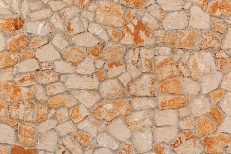 Concrete block. Outdoor yellow concrete blocks, stone wall texture close up.の写真素材