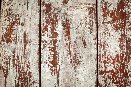 Peeling paint on the wall. Old wall texture with the white peeling paint close up.の写真素材