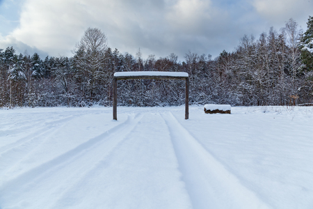 tracks from the wheels of machine on to snow, winter landscape on a gladeの写真素材
