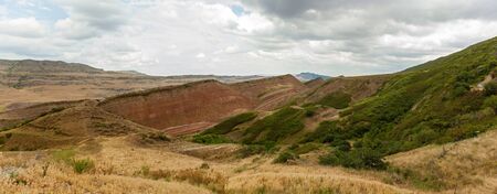 landscape of the yellow mountains with forest, sky and cloudsの写真素材