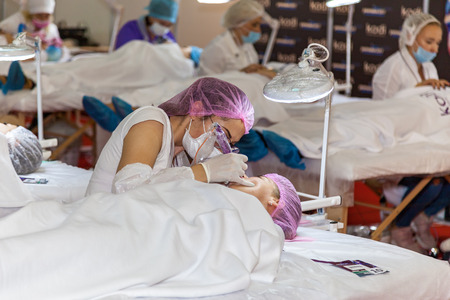 Ukraine Kiev 22 September 2017: Cosmetology doctor makes the procedure a woman face cleaningのeditorial素材