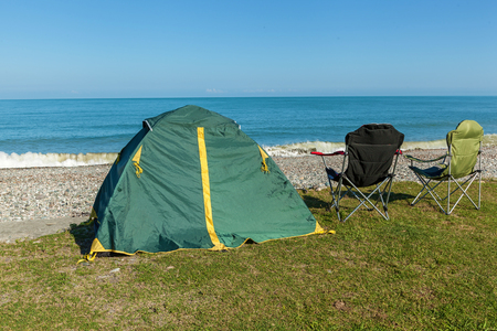 Tent on the beach with two chairs standing on the grass. Tent on the beach..journey to Georgiaの写真素材