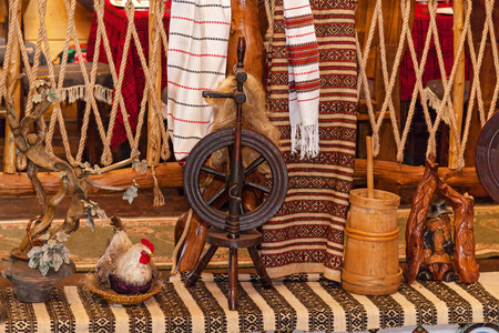 Old wooden spinning wheel, Russian folk art. Wooden spinning wheel decor for a restaurant in retro style.wooden spinning wheelの写真素材