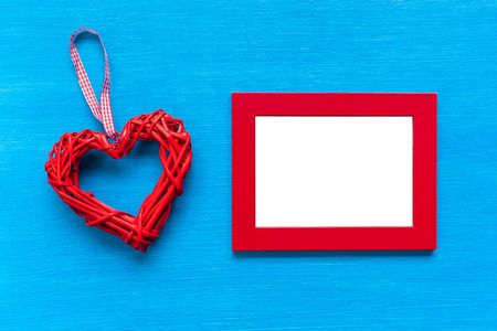 Red frame and heart lies on a turquoise table. Red frame and heart on the table..の写真素材
