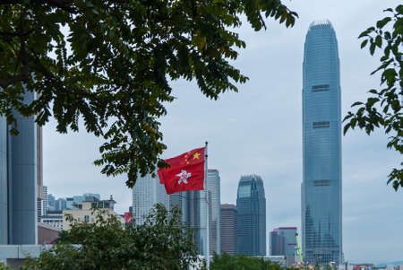 City skyscrapers are famous landmarks of Hong Kong. flag of Hong Kong. Hong Kong is one of the most densely populated areas in the world.の写真素材