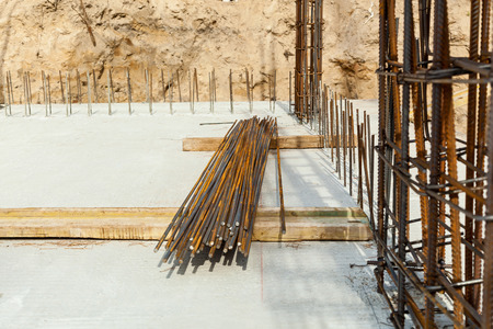 Construction workers fabricating steel reinforcement bar at the construction site.The reinforcement...