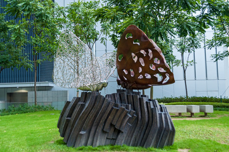 Hong Kong, China January 29, 2016: A metal sculpture of two white and brown butterflies sitting on a rock in a park. Hong Kong sculpturesのeditorial素材