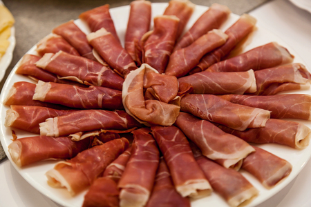 A plate with prosciutto for a buffet, background and texture of prosciuttoの写真素材