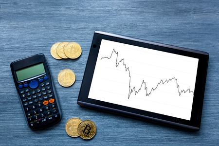 Cryptocurrency Gold bitcoin, coins, bitcoin, tablet and calculator on wooden background, bitcoin mining conceptの写真素材